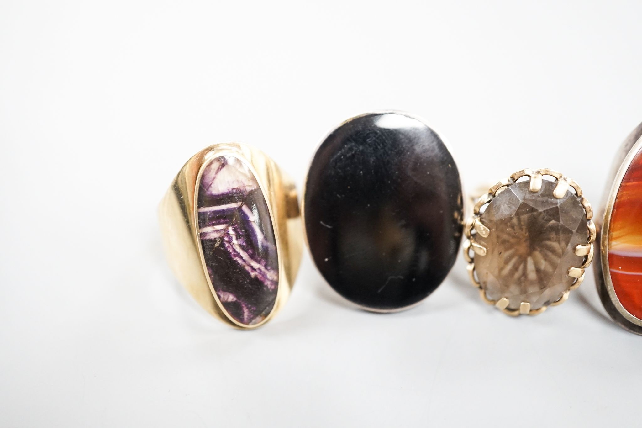 Three assorted 9ct gold and gem set dress rings, including blue john, smoky quartz and tiger's eye quartz, gross 23.9 grams and two white metal and hardstone set dress rings.